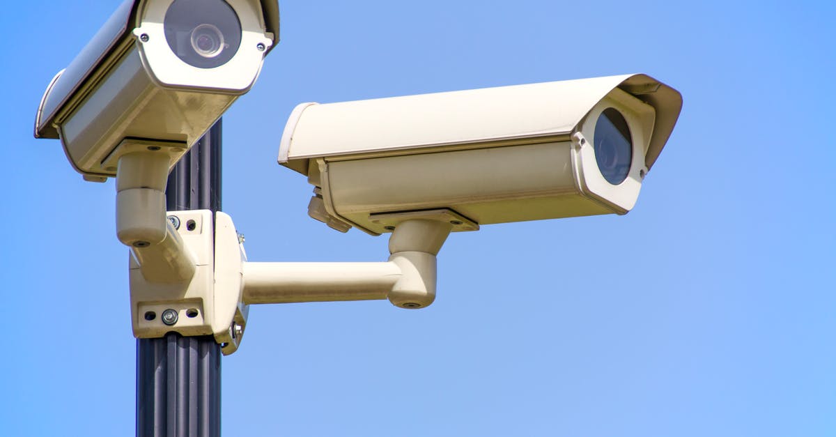 Surveillance cameras on a pole keeping areas secure.