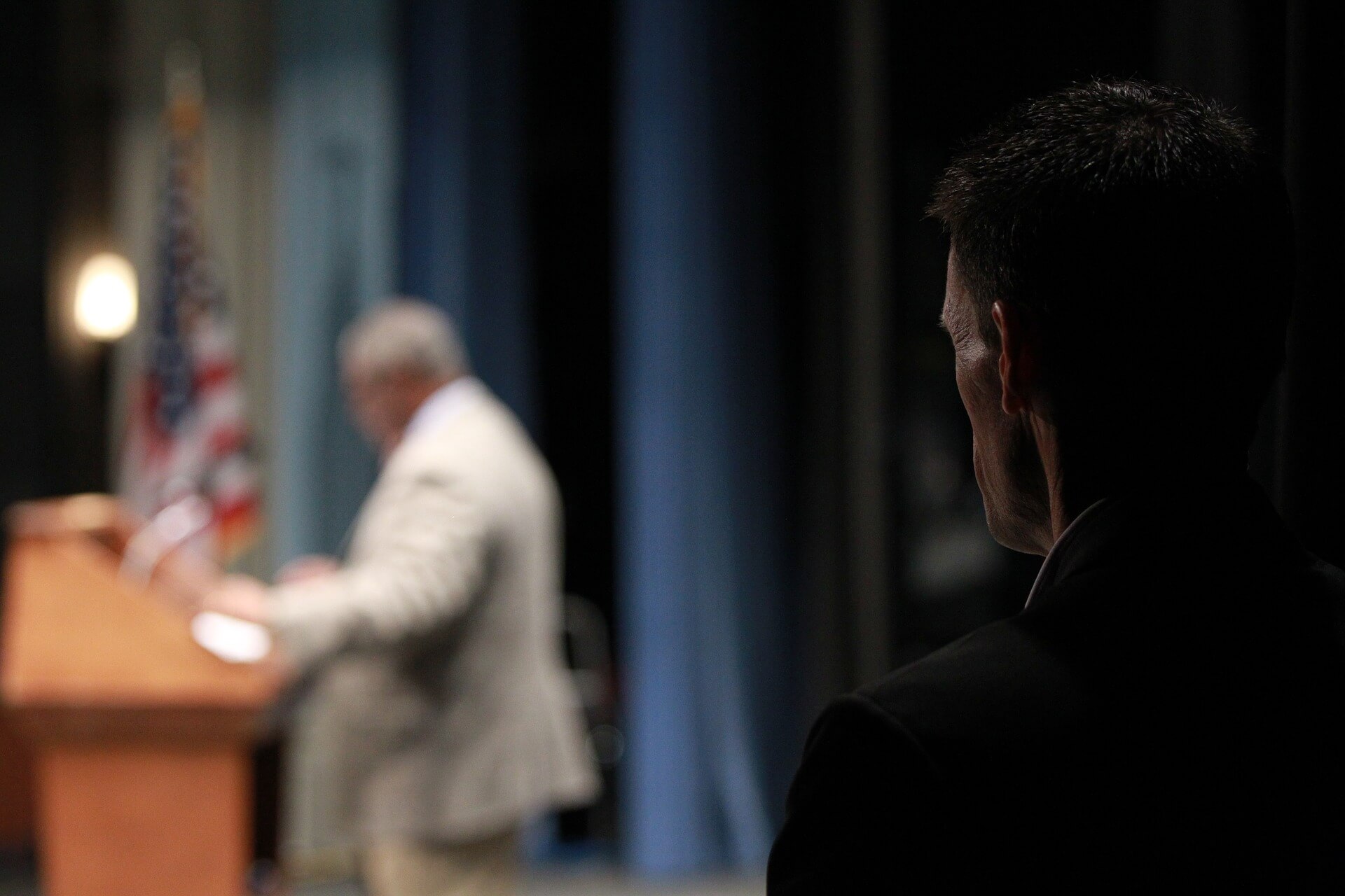 security-bodyguard Body Guard protecting an executive while he speaks.