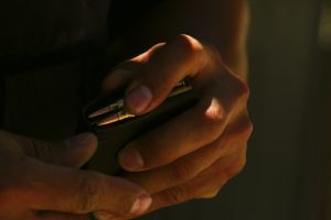 Man loading bullets in a rifle clip.