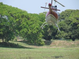 Helicopter flying low to the ground.