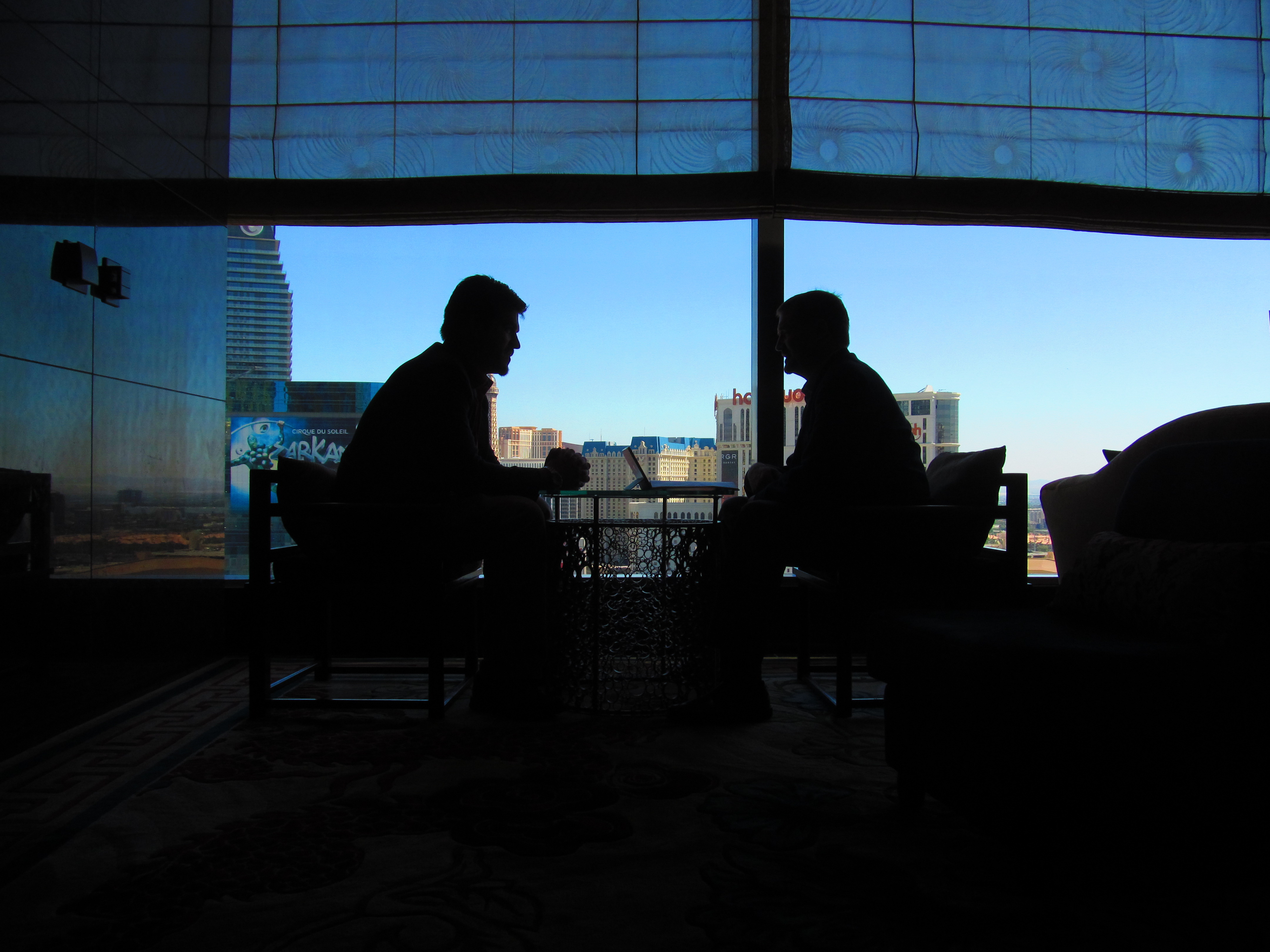 Two men in silhouette talking about Private Corporate Security