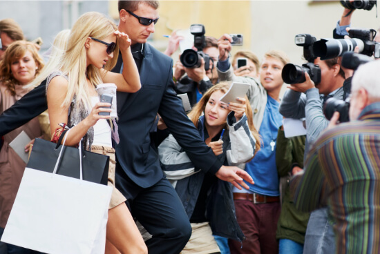 Woman escorted by security personel