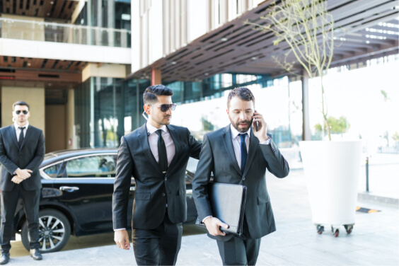 Executive with two concierge guards protecting him.