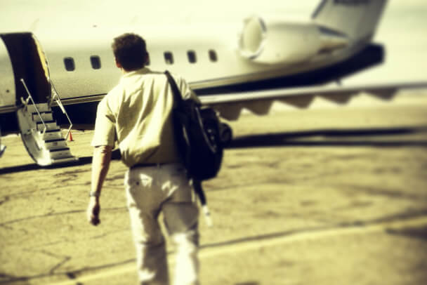 Man walking to plane with backpack