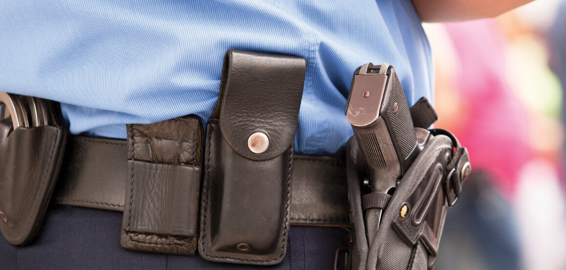 Security Guard's equipped belt with cuffs and firearm.