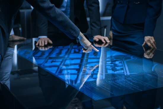 Men surveying a map on a table assessing threats.