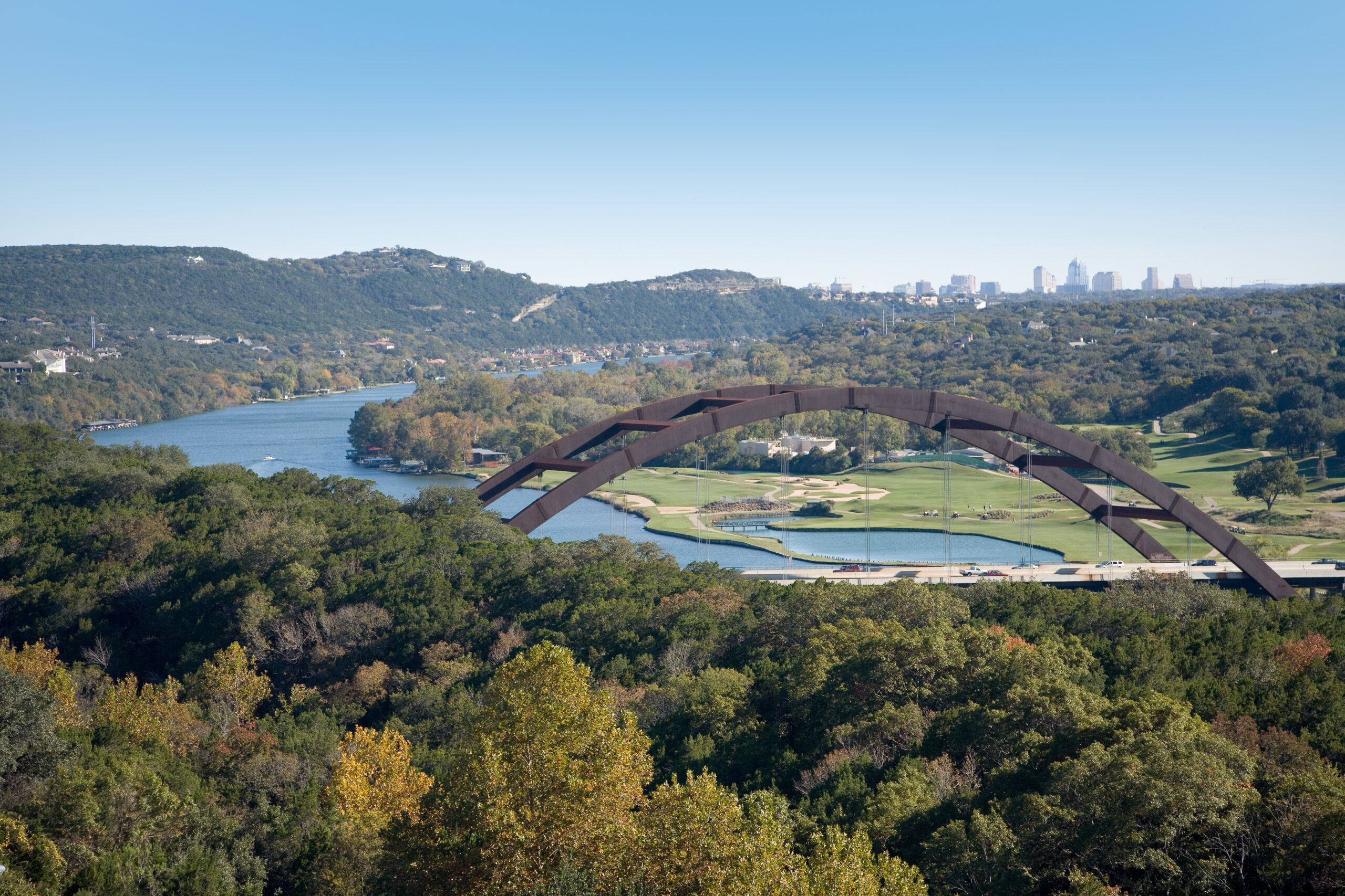 Austin Over the Loop 360 Bridge. From west of downtown Austin looking east. This is the Pennybacker bridge, which the local Austinites know simply as The Loop 360 Bridge. It was a cool November afternoon and the trees were just starting to change colors. This portion of the Colorado river is named Lake Austin.