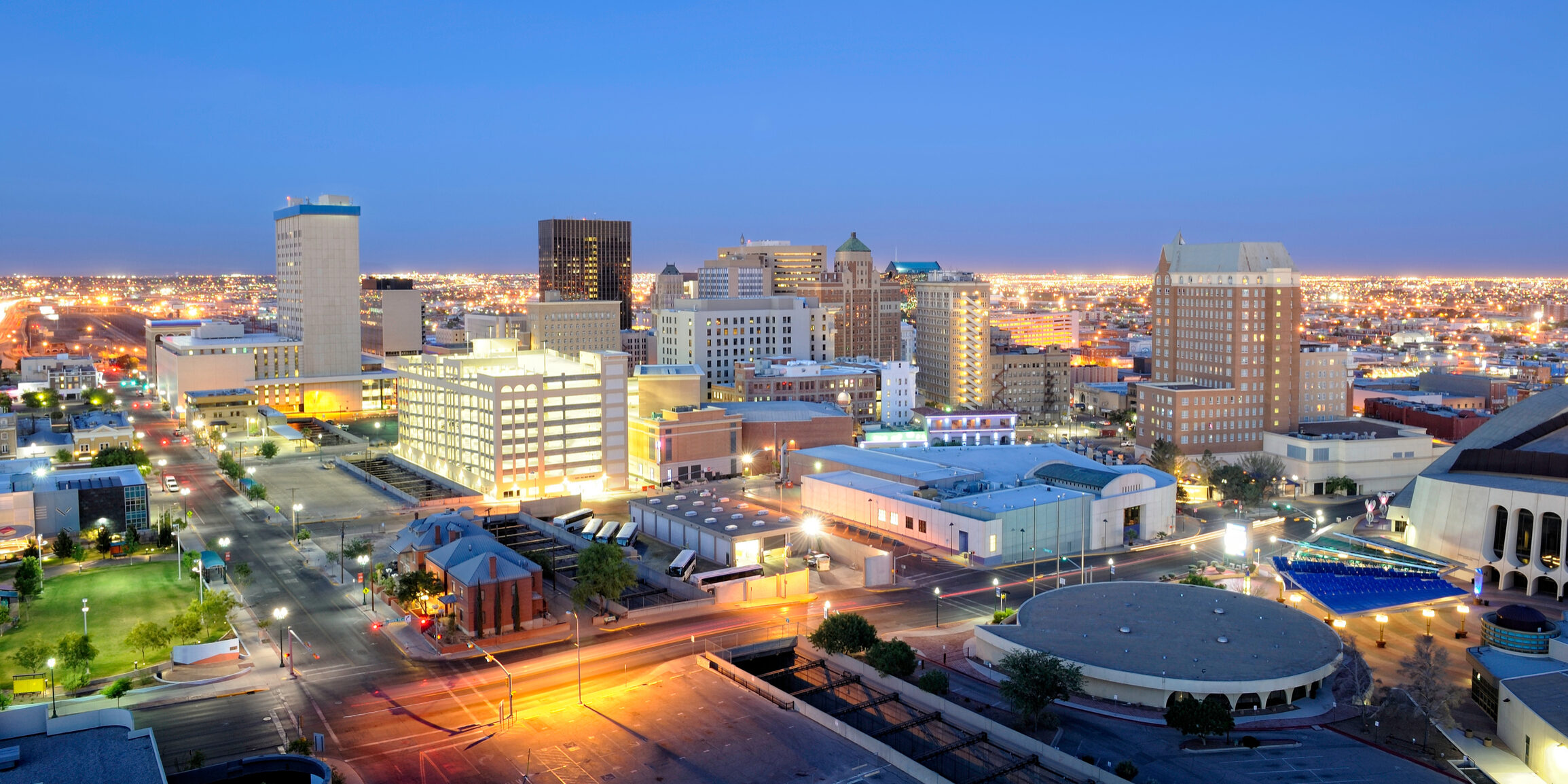 Downtown El Paso Texas skyline seen just after sunset featuring many buildings and street lights